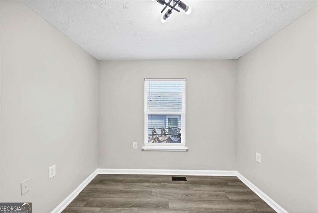 2478 Verbena Cir NW, Atlanta, GA 30314 - empty room featuring visible vents, a textured ceiling, baseboards, and wood finished floors