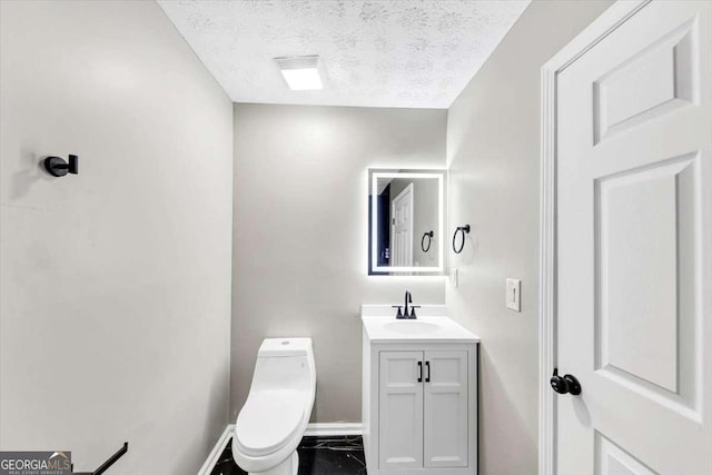 2478 Verbena Cir NW, Atlanta, GA 30314 - half bathroom featuring baseboards, toilet, vanity, and a textured ceiling