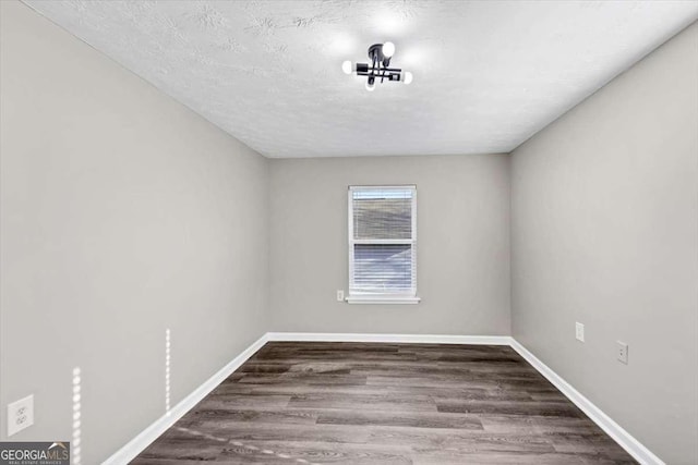 2478 Verbena Cir NW, Atlanta, GA 30314 - spare room with a textured ceiling, baseboards, and wood finished floors