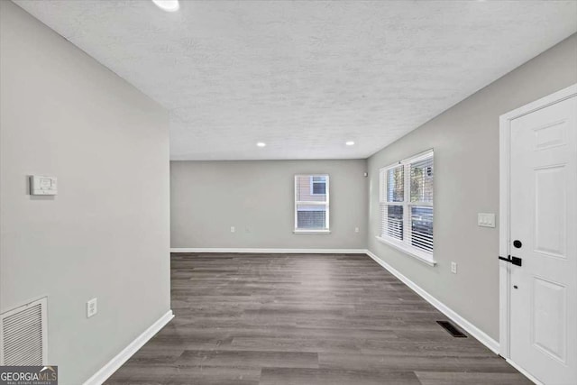 2478 Verbena Cir NW, Atlanta, GA 30314 - foyer with dark wood-type flooring, baseboards, visible vents, and a textured ceiling