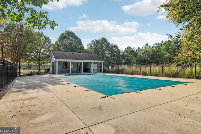 view of swimming pool featuring a fenced in pool, a patio, and fence