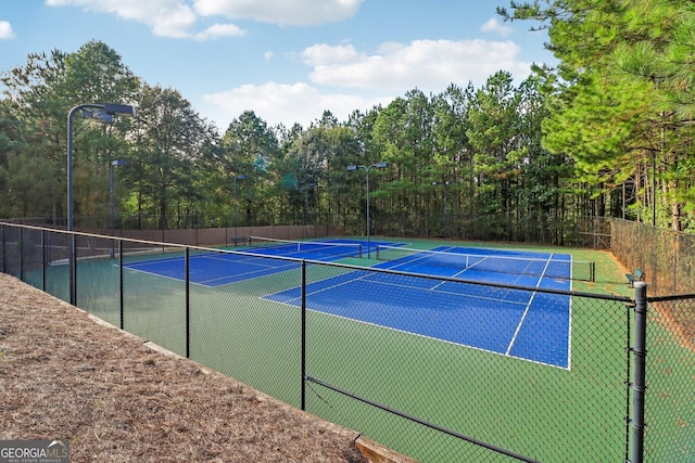 view of sport court featuring fence