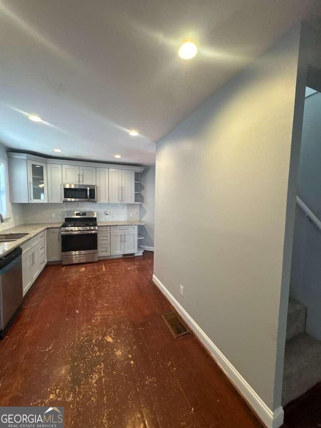 3426 Glenwood Rd, Decatur, GA 30032 - kitchen featuring baseboards, a sink, decorative backsplash, light countertops, and appliances with stainless steel finishes