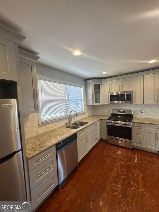 3426 Glenwood Rd, Decatur, GA 30032 - kitchen with light stone counters, a sink, stainless steel appliances, glass insert cabinets, and backsplash