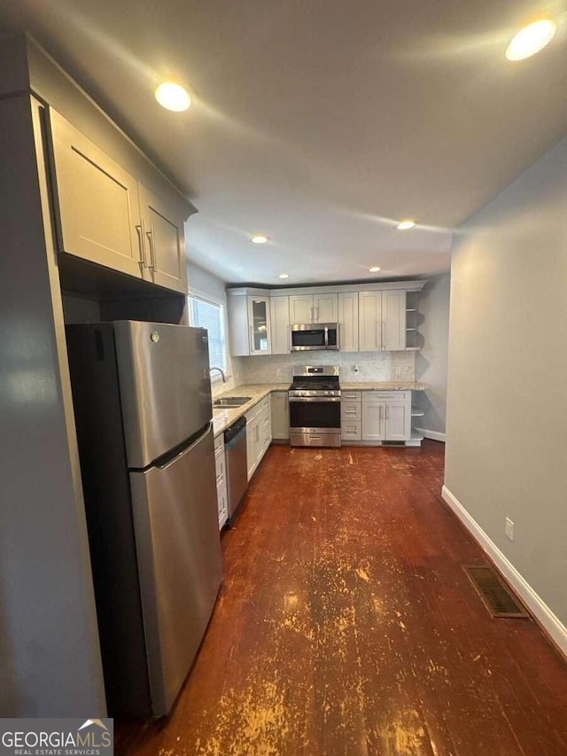 3426 Glenwood Rd, Decatur, GA 30032 - kitchen featuring a sink, open shelves, appliances with stainless steel finishes, light countertops, and baseboards