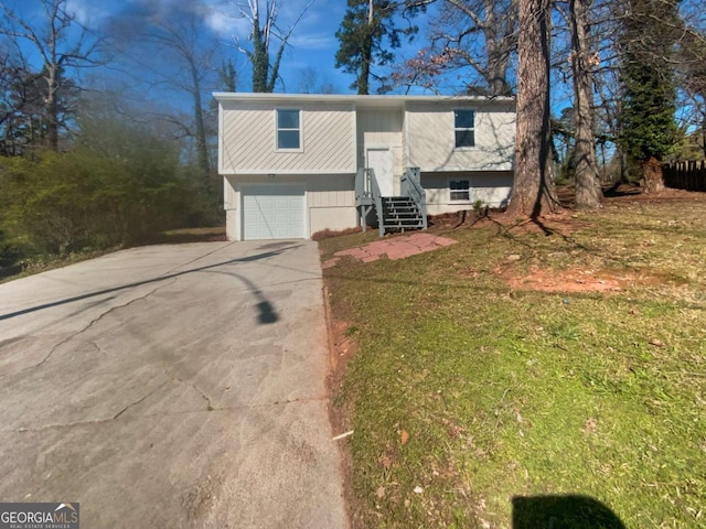 5216 Sweet Air Ln, Stone Mountain, GA 30088 - raised ranch featuring driveway, an attached garage, and entry steps