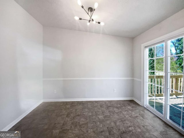 5216 Sweet Air Ln, Stone Mountain, GA 30088 - spare room with a chandelier and baseboards