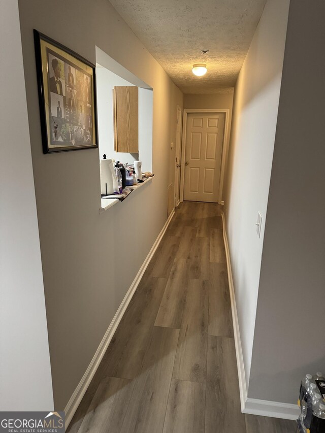 18102 Waldrop Cv, Decatur, GA 30034 - hall featuring wood finished floors, visible vents, baseboards, and a textured ceiling