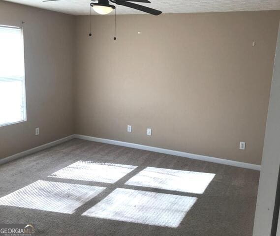 18102 Waldrop Cv, Decatur, GA 30034 - empty room featuring carpet flooring, baseboards, and ceiling fan