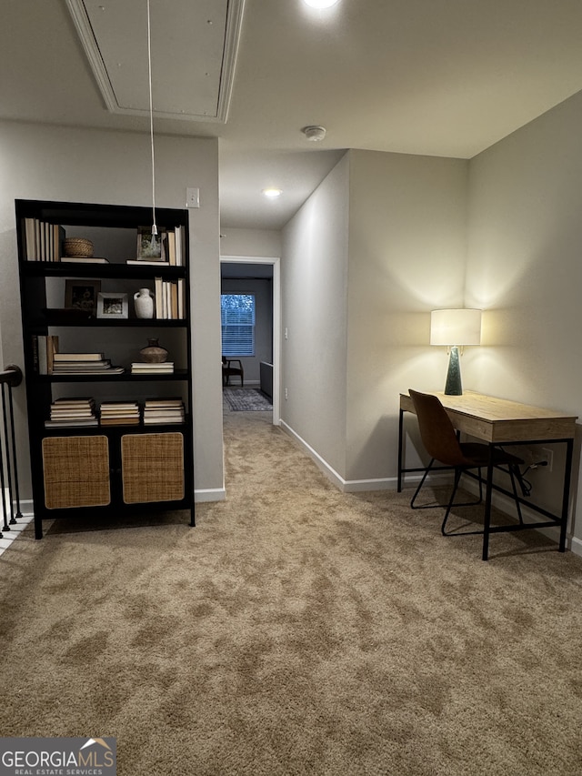 carpeted office featuring attic access and baseboards