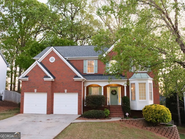 912 Tanners Point Dr, Lawrenceville, GA 30044 - traditional-style house featuring a garage, fence, brick siding, a shingled roof, and concrete driveway