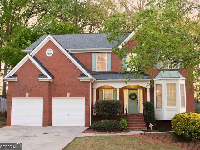 912 Tanners Point Dr, Lawrenceville, GA 30044 - traditional home featuring an attached garage, roof with shingles, driveway, and brick siding
