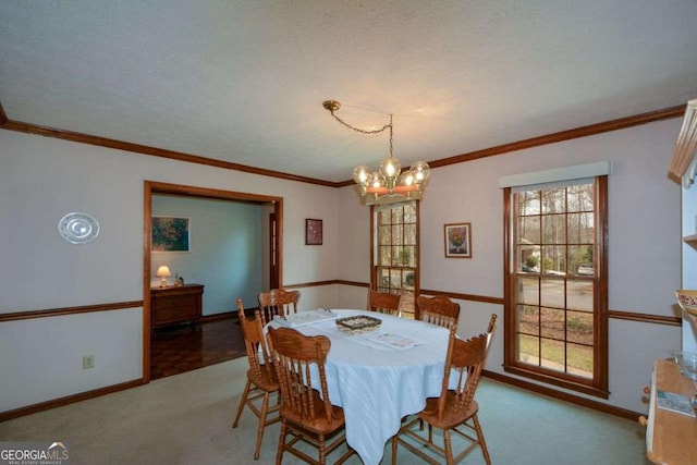carpeted dining space with baseboards, ornamental molding, and an inviting chandelier