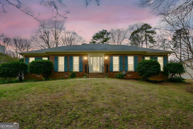 single story home featuring brick siding and a front yard