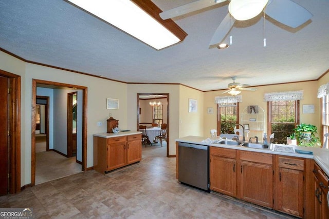 kitchen featuring light countertops, stainless steel dishwasher, a sink, and ceiling fan with notable chandelier