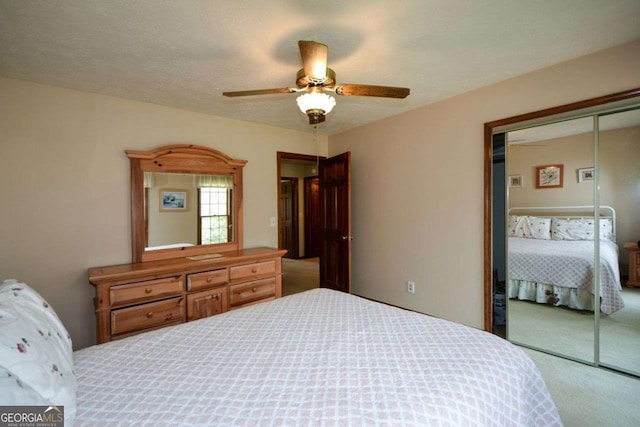 carpeted bedroom with a closet and a ceiling fan