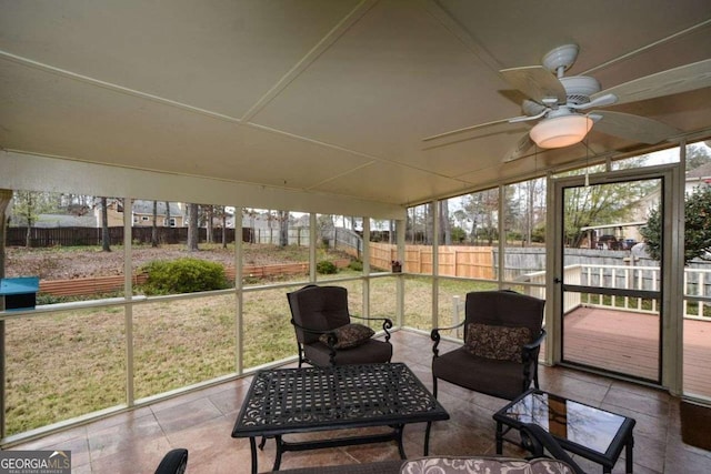 sunroom / solarium with a ceiling fan