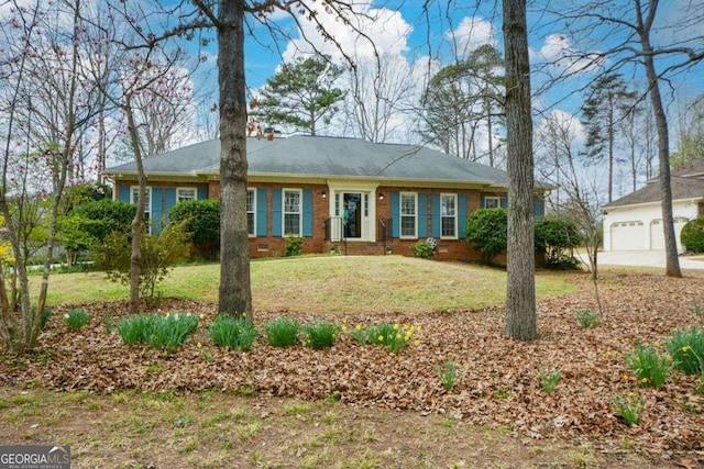 view of front of house with driveway, fence, brick siding, a garage, and a front yard