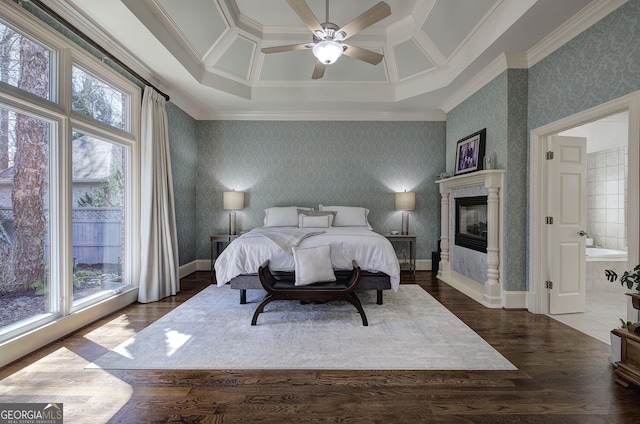 bedroom with wallpapered walls, dark wood-style flooring, baseboards, and multiple windows