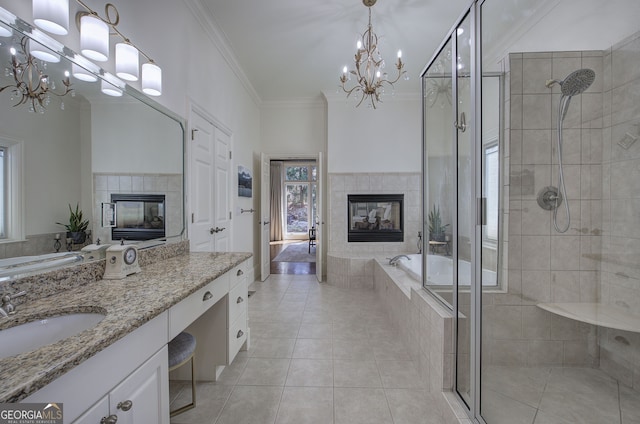 bathroom featuring ornamental molding, a tile fireplace, a stall shower, and a chandelier