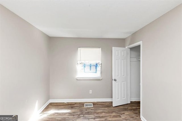 3671 Satellite Blvd, Ellenwood, GA 30294 - unfurnished bedroom with visible vents, baseboards, a closet, and wood finished floors
