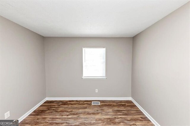 3671 Satellite Blvd, Ellenwood, GA 30294 - spare room with visible vents, baseboards, and wood finished floors
