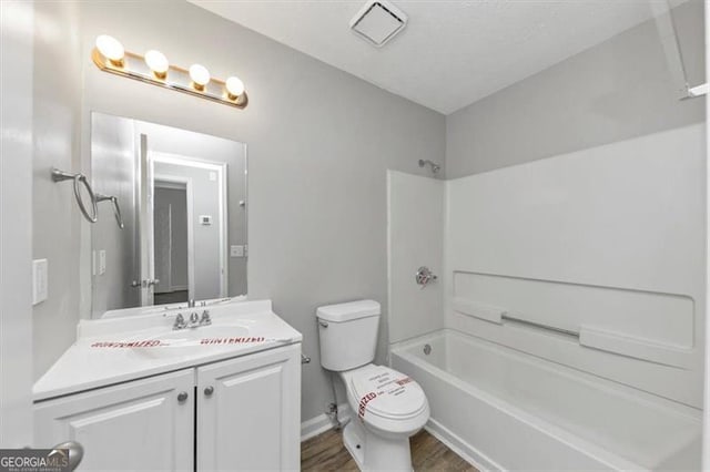 3671 Satellite Blvd, Ellenwood, GA 30294 - bathroom with vanity, wood finished floors, visible vents, tub / shower combination, and toilet