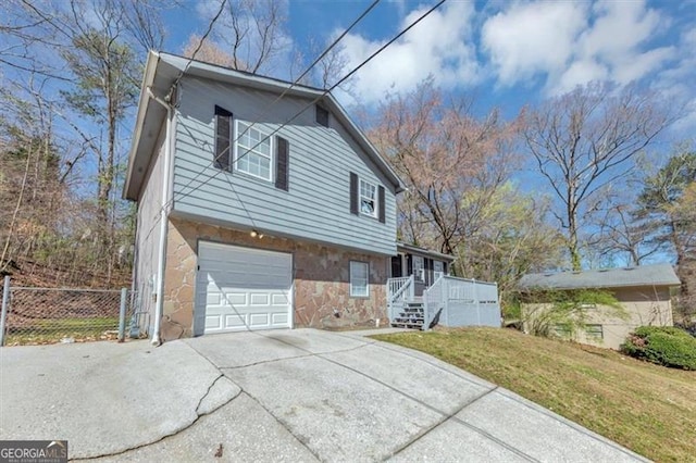 3671 Satellite Blvd, Ellenwood, GA 30294 - view of side of property with fence, driveway, covered porch, a garage, and a lawn