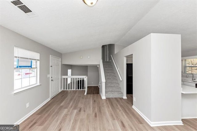 3671 Satellite Blvd, Ellenwood, GA 30294 - entryway featuring visible vents, a textured ceiling, wood finished floors, and vaulted ceiling