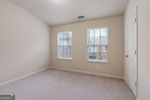 3879 Brockenhurst Dr, Buford, GA 30519 - spare room with baseboards, visible vents, and light carpet