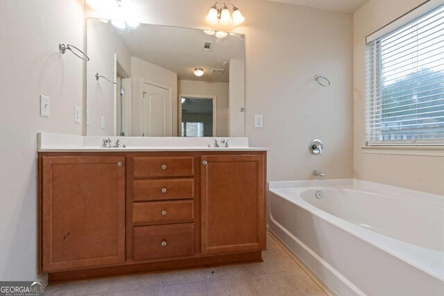 3879 Brockenhurst Dr, Buford, GA 30519 - full bath with double vanity, a garden tub, tile patterned floors, and a sink