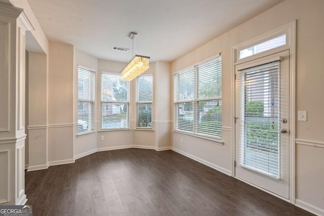 3879 Brockenhurst Dr, Buford, GA 30519 - unfurnished dining area featuring visible vents, baseboards, and dark wood finished floors