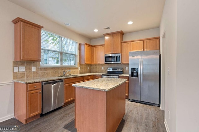 3879 Brockenhurst Dr, Buford, GA 30519 - kitchen with decorative backsplash, wood finished floors, appliances with stainless steel finishes, and a sink