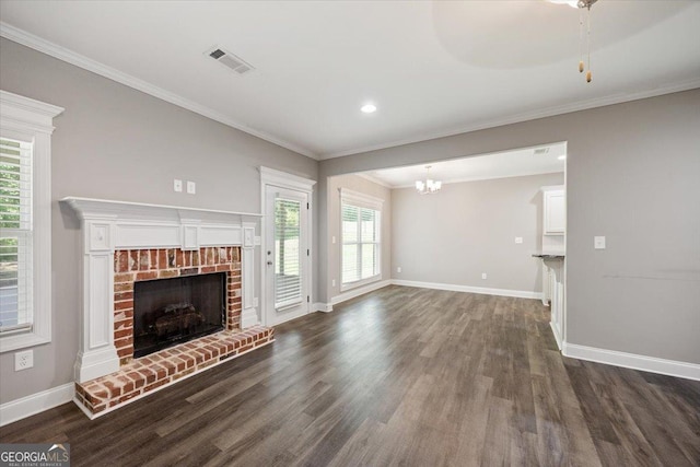 14 Carters Way, Forsyth, GA 31029 - unfurnished living room with baseboards, dark wood-type flooring, a fireplace, a chandelier, and ornamental molding