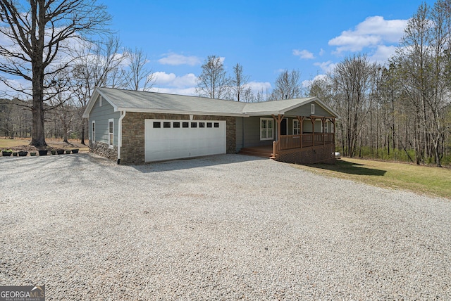 1875 Ebenezer Rd SW, Conyers, GA 30094 - ranch-style home featuring covered porch, driveway, an attached garage, and stone siding