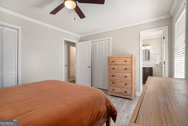 1875 Ebenezer Rd SW, Conyers, GA 30094 - bedroom featuring light wood-style flooring, crown molding, ensuite bathroom, two closets, and a ceiling fan