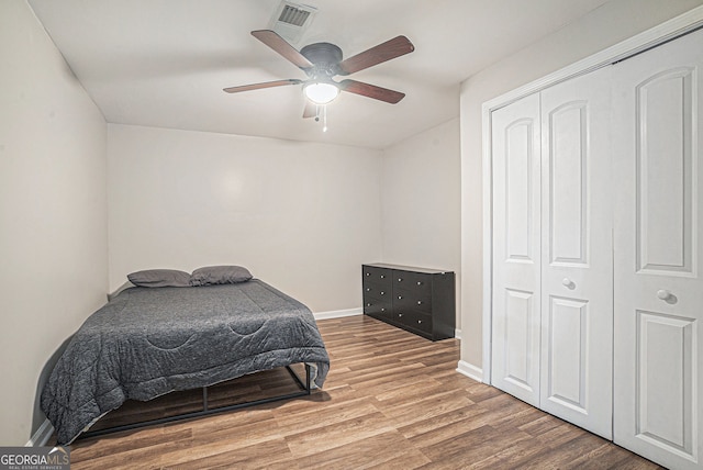 1875 Ebenezer Rd SW, Conyers, GA 30094 - bedroom featuring wood finished floors, a closet, ceiling fan, and baseboards