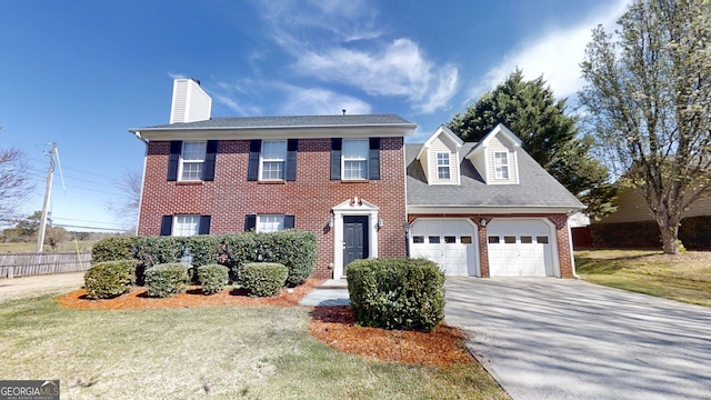 921 Dunagan Way, Lawrenceville, GA 30045 - colonial house featuring brick siding, an attached garage, a chimney, concrete driveway, and a shingled roof