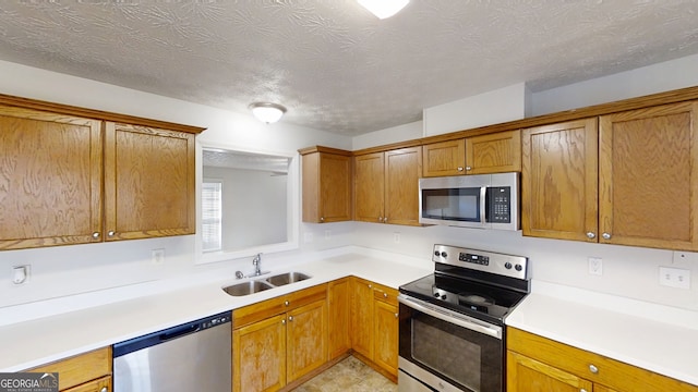 921 Dunagan Way, Lawrenceville, GA 30045 - kitchen featuring stainless steel appliances, brown cabinets, light countertops, and a textured ceiling