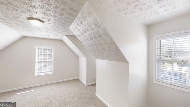 921 Dunagan Way, Lawrenceville, GA 30045 - bonus room featuring a textured ceiling, lofted ceiling, and carpet flooring