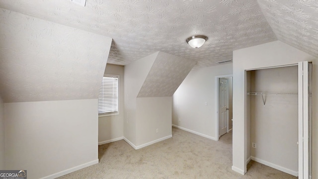 921 Dunagan Way, Lawrenceville, GA 30045 - bonus room with vaulted ceiling, a textured ceiling, and carpet floors