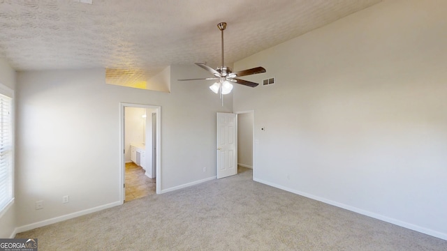 921 Dunagan Way, Lawrenceville, GA 30045 - unfurnished bedroom featuring carpet, vaulted ceiling, and a textured ceiling