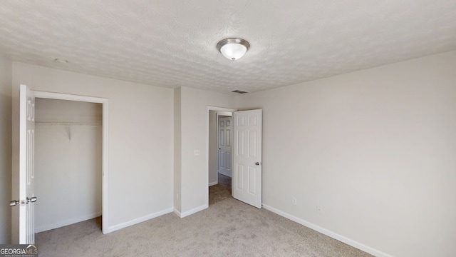 921 Dunagan Way, Lawrenceville, GA 30045 - unfurnished bedroom featuring carpet, a closet, and a textured ceiling