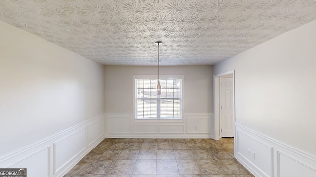 921 Dunagan Way, Lawrenceville, GA 30045 - unfurnished dining area with a decorative wall and a wainscoted wall