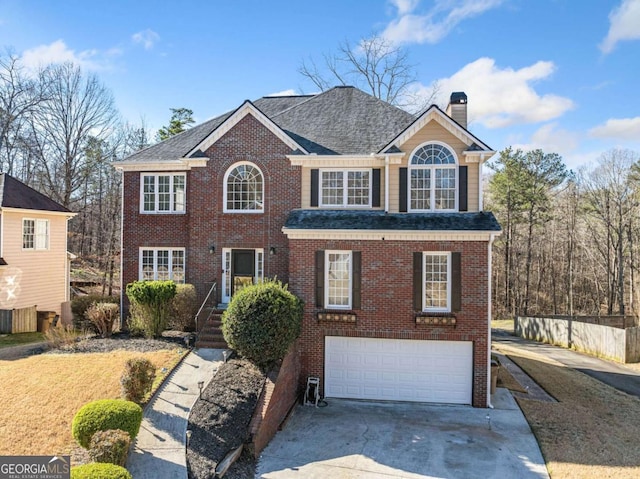 view of front of home featuring driveway, a shingled roof, a garage, brick siding, and a chimney