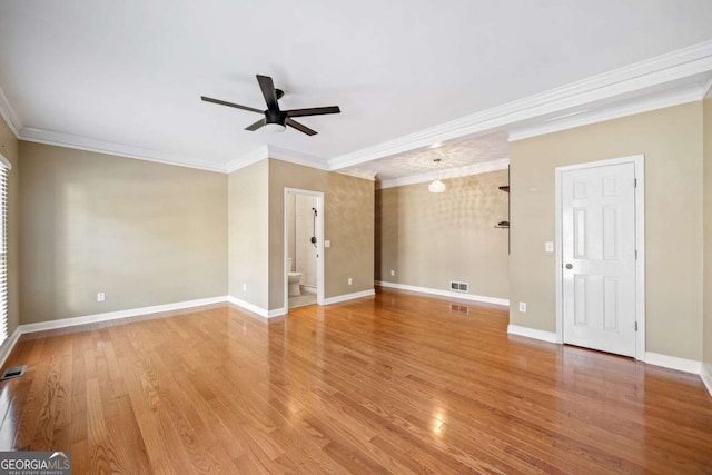 unfurnished room with visible vents, baseboards, ceiling fan, ornamental molding, and light wood-style floors