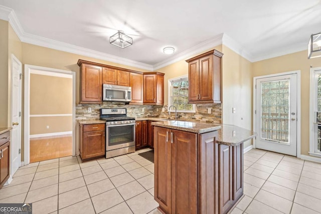 kitchen featuring light stone counters, stainless steel appliances, tasteful backsplash, and light tile patterned flooring