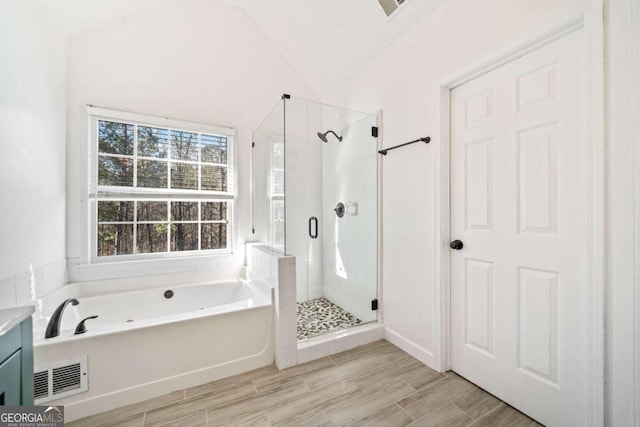 bathroom featuring visible vents, a garden tub, vanity, a shower stall, and wood tiled floor