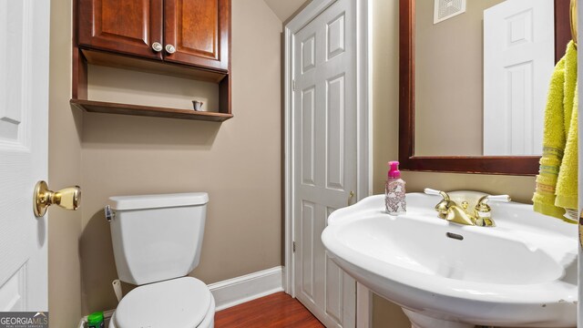 26 The Trl SE, Lindale, GA 30147 - half bath featuring a sink, toilet, wood finished floors, and baseboards