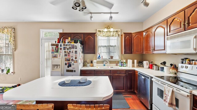 26 The Trl SE, Lindale, GA 30147 - kitchen with white appliances, a sink, track lighting, and light countertops